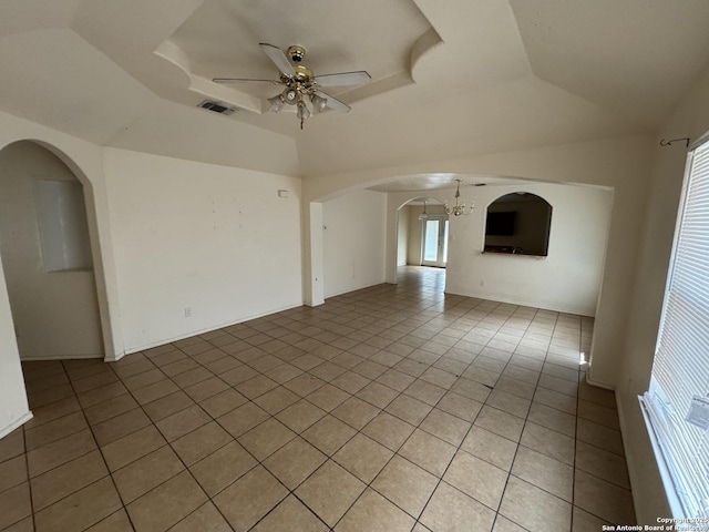 6547 Estes Flts, San Antonio, TX 78242 - empty room featuring arched walkways, light tile patterned floors, ceiling fan, a raised ceiling, and a chandelier