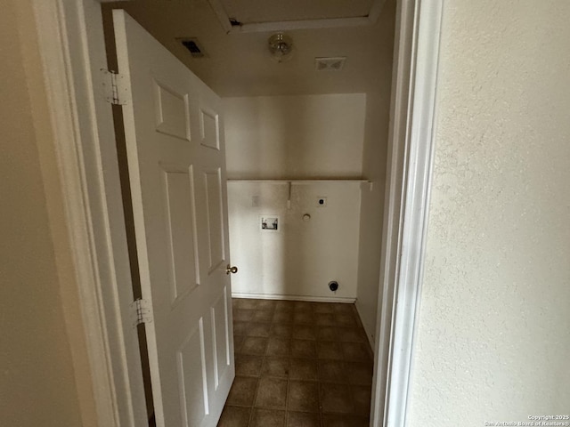 6547 Estes Flts, San Antonio, TX 78242 - laundry area with electric dryer hookup, hookup for a washing machine, dark tile patterned flooring, and a textured wall