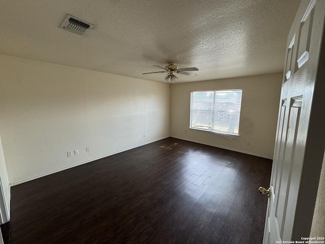 6547 Estes Flts, San Antonio, TX 78242 - unfurnished room with a ceiling fan, dark wood-style flooring, and a textured ceiling