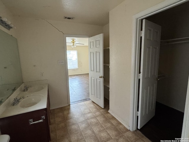 6547 Estes Flts, San Antonio, TX 78242 - full bath featuring double vanity and a ceiling fan