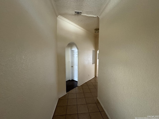 6547 Estes Flts, San Antonio, TX 78242 - hallway with arched walkways, ornamental molding, a textured wall, tile patterned flooring, and a textured ceiling