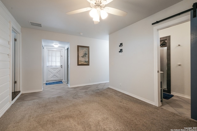 539 Rittiman, San Antonio, TX 78209 - tiled spare room with a barn door, carpet floors, and a ceiling fan