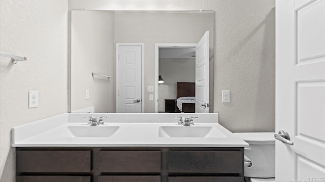 6314 Hibiscus Fls, San Antonio, TX 78218 - ensuite bathroom featuring a textured wall and double vanity