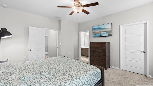 6314 Hibiscus Fls, San Antonio, TX 78218 - bedroom with light carpet, ensuite bathroom, and a ceiling fan