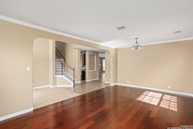 3415 Highline, San Antonio, TX 78261 - empty room with arched walkways, a chandelier, wood finished floors, ornamental molding, and stairway