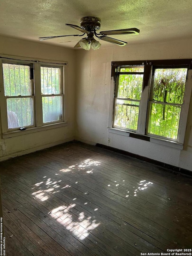 227 Noria St, San Antonio, TX 78207 - empty room featuring a ceiling fan, wood-type flooring, a textured ceiling, and plenty of natural light