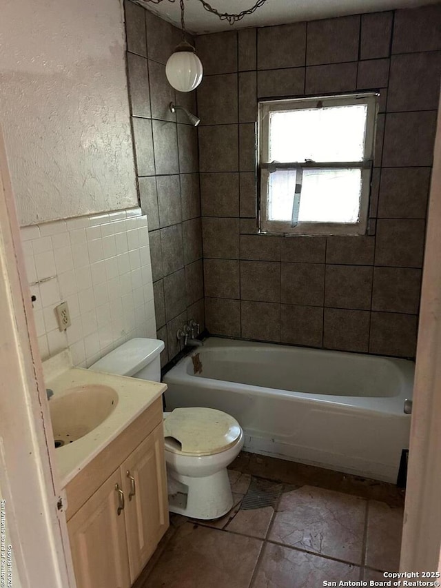 227 Noria St, San Antonio, TX 78207 - bathroom featuring tile walls, vanity, and tub / shower combination