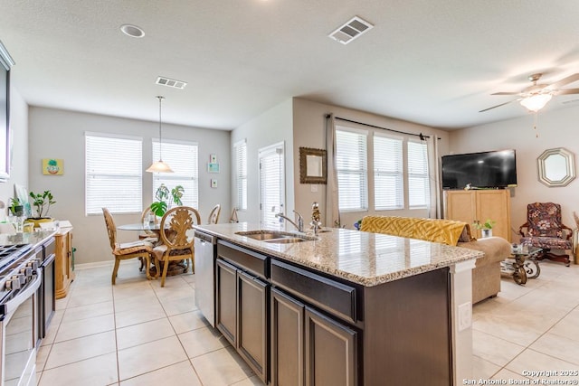 6723 Dashmoor, San Antonio, TX 78244 - kitchen featuring light tile patterned flooring, appliances with stainless steel finishes, ceiling fan, and plenty of natural light