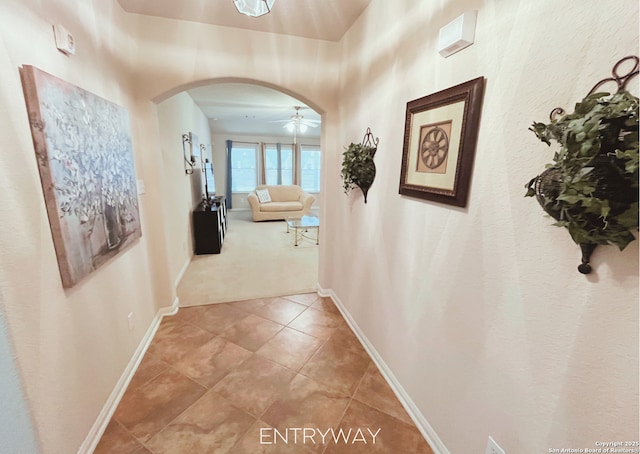 4018 Matson Mnr, Converse, TX 78109 - hall with arched walkways, light tile patterned flooring, and light colored carpet