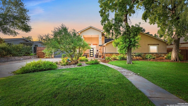 1069 Ivy Ln, Terrell Hills, TX 78209 - view of front of house with stucco siding, stone siding, and a yard