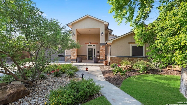 1069 Ivy Ln, Terrell Hills, TX 78209 - view of front of house with stone siding, stucco siding, and a front lawn