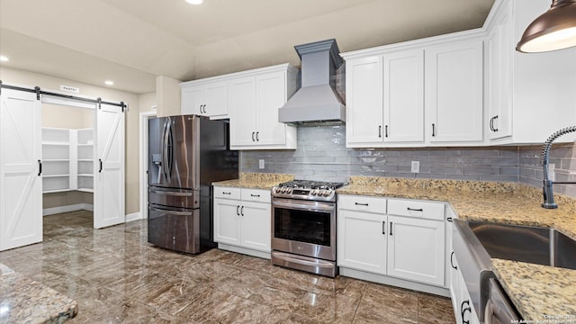 1069 Ivy Ln, Terrell Hills, TX 78209 - kitchen with stainless steel appliances, premium range hood, recessed lighting, a barn door, and white cabinets