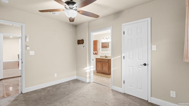 1069 Ivy Ln, Terrell Hills, TX 78209 - unfurnished bedroom featuring ensuite bathroom, light carpet, and ceiling fan