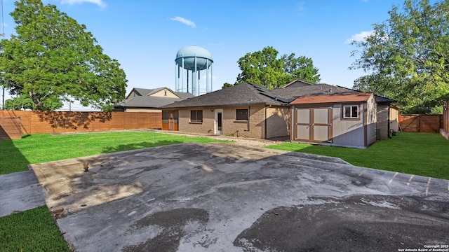 1069 Ivy Ln, Terrell Hills, TX 78209 - back of property with a shed, a fenced backyard, a patio, and brick siding