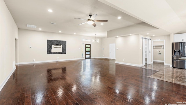1069 Ivy Ln, Terrell Hills, TX 78209 - unfurnished living room featuring a ceiling fan, wood-type flooring, a barn door, and recessed lighting