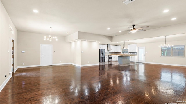 1069 Ivy Ln, Terrell Hills, TX 78209 - unfurnished living room with a chandelier, ceiling fan, recessed lighting, and dark wood finished floors