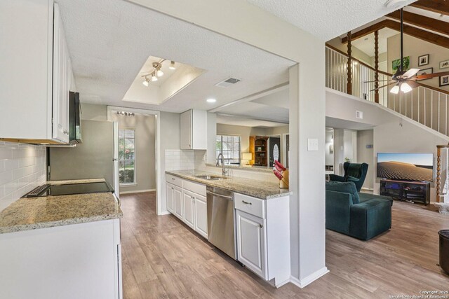 2019 Crooked, San Antonio, TX 78232 - kitchen featuring stainless steel dishwasher, open floor plan, white cabinetry, light wood finished floors, and a textured ceiling