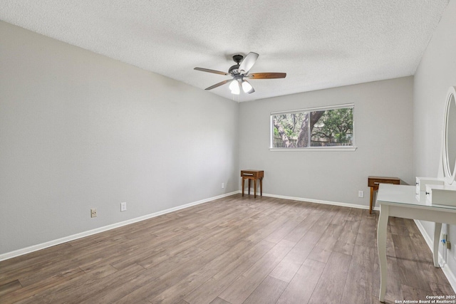 2019 Crooked, San Antonio, TX 78232 - empty room with a ceiling fan, wood finished floors, and a textured ceiling