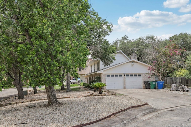 2019 Crooked, San Antonio, TX 78232 - obstructed view of property featuring driveway, a garage, a chimney, and brick siding