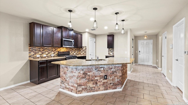 702 Pelican Pt, San Antonio, TX 78221 - kitchen with stainless steel appliances, tasteful backsplash, dark brown cabinetry, and light stone countertops
