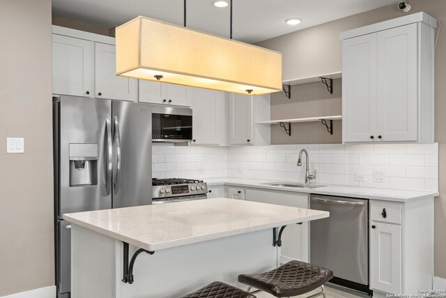 7934 Teak Ln, San Antonio, TX 78209 - kitchen featuring appliances with stainless steel finishes, open shelves, a breakfast bar area, decorative backsplash, and recessed lighting