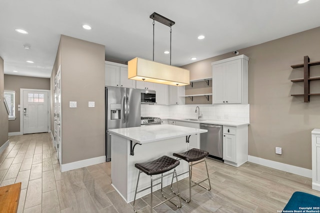 7934 Teak Ln, San Antonio, TX 78209 - kitchen with appliances with stainless steel finishes, open shelves, wood tiled floors, light countertops, and decorative backsplash