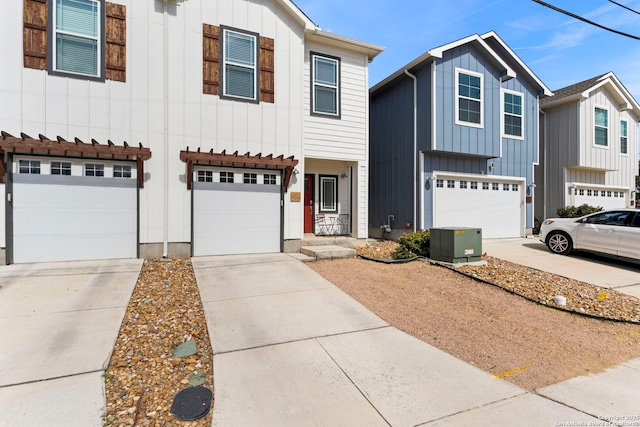 7934 Teak Ln, San Antonio, TX 78209 - view of front of house with an attached garage, board and batten siding, and driveway