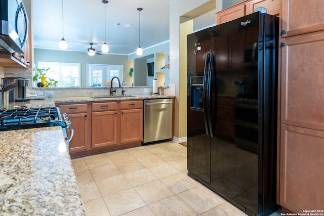 12610 Lotus Rdg, San Antonio, TX 78253 - kitchen featuring stainless steel appliances, ceiling fan, decorative light fixtures, and brown cabinetry