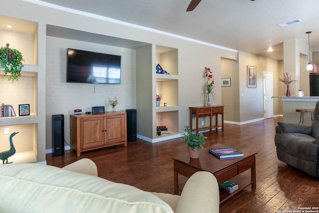 12610 Lotus Rdg, San Antonio, TX 78253 - living area with wood finished floors, built in shelves, ceiling fan, crown molding, and a textured ceiling