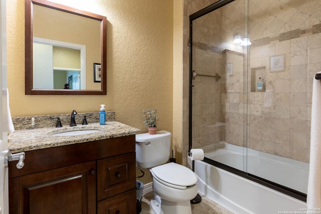 12610 Lotus Rdg, San Antonio, TX 78253 - bathroom featuring a textured wall, vanity, and bath / shower combo with glass door