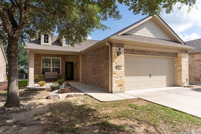 12610 Lotus Rdg, San Antonio, TX 78253 - view of front facade with a garage, roof with shingles, driveway, and stone siding