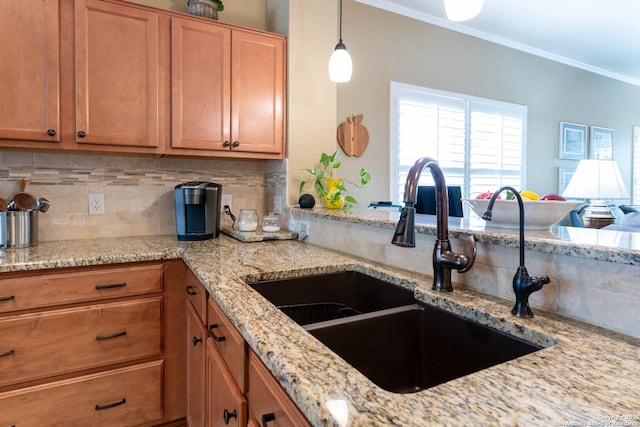 12610 Lotus Rdg, San Antonio, TX 78253 - kitchen featuring decorative backsplash, crown molding, light stone counters, brown cabinetry, and decorative light fixtures