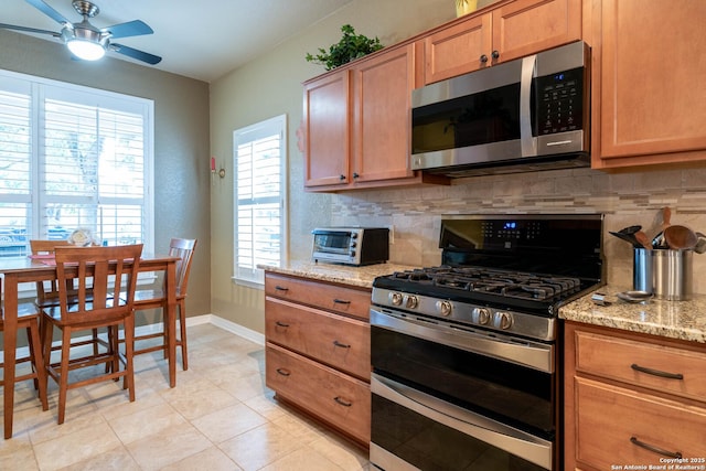 12610 Lotus Rdg, San Antonio, TX 78253 - kitchen featuring stainless steel appliances, backsplash, ceiling fan, and light stone countertops