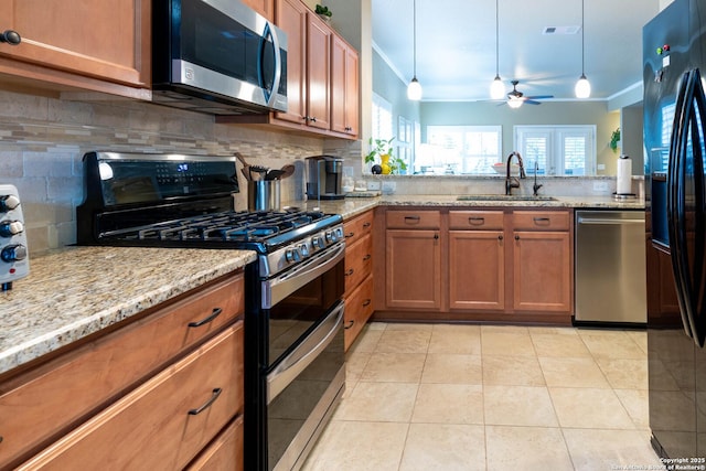 12610 Lotus Rdg, San Antonio, TX 78253 - kitchen with stainless steel appliances, crown molding, brown cabinets, tasteful backsplash, and a ceiling fan