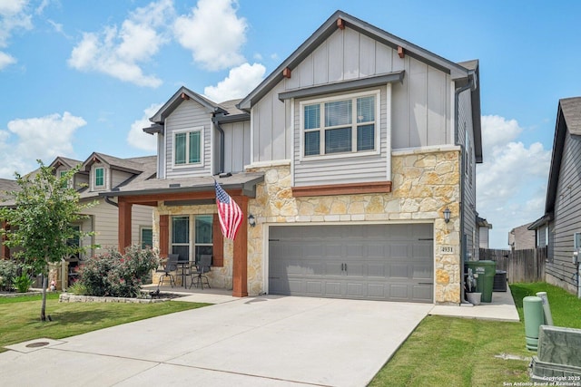 4931 Ranahan Pass, Saint Hedwig, TX 78152 - view of front of house with stone siding, board and batten siding, an attached garage, and concrete driveway