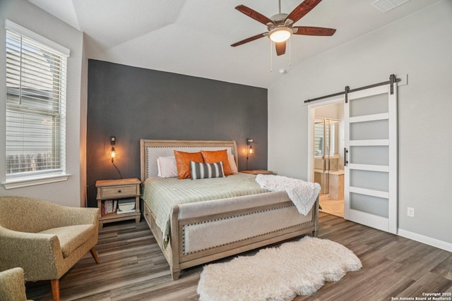 4931 Ranahan Pass, Saint Hedwig, TX 78152 - bedroom featuring lofted ceiling, a barn door, wood finished floors, and multiple windows