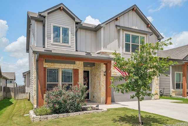 4931 Ranahan Pass, Saint Hedwig, TX 78152 - view of front of home with board and batten siding, concrete driveway, a garage, and stone siding