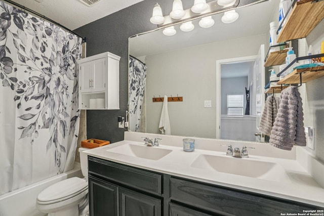 4931 Ranahan Pass, Saint Hedwig, TX 78152 - bathroom with double vanity, shower / bath combo, and a textured wall