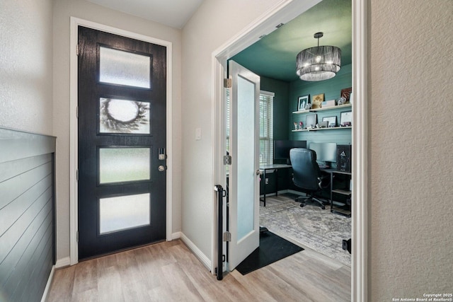 4931 Ranahan Pass, Saint Hedwig, TX 78152 - entrance foyer with wood finished floors, a chandelier, and a textured wall