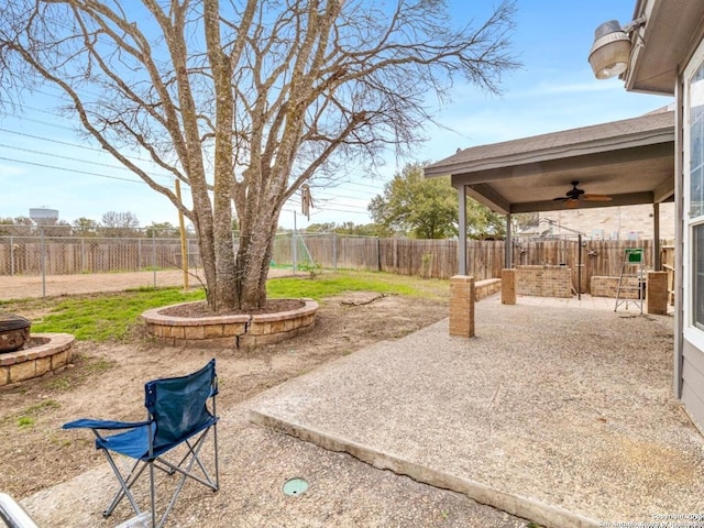 6608 Woodbell, Live Oak, TX 78233 - fenced backyard with ceiling fan, a patio area, and an outdoor fire pit