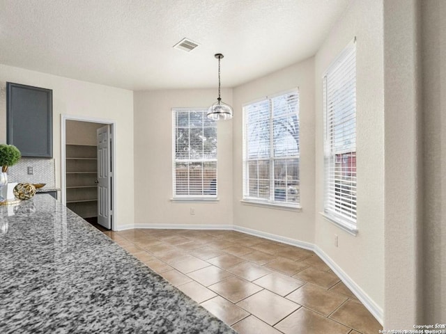 6608 Woodbell, Live Oak, TX 78233 - unfurnished dining area with light tile patterned floors and a textured ceiling