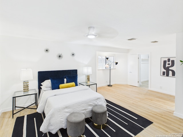 7007 Elk Trl, San Antonio, TX 78244 - bedroom featuring light wood-style floors, ceiling fan, and a walk in closet