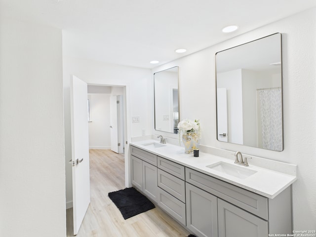 7007 Elk Trl, San Antonio, TX 78244 - full bath featuring double vanity, wood finished floors, and recessed lighting
