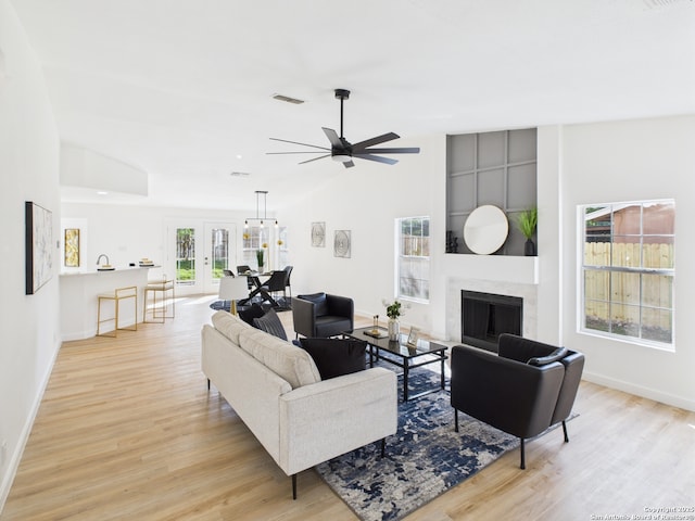 7007 Elk Trl, San Antonio, TX 78244 - living area with light wood-style floors, vaulted ceiling, a ceiling fan, and a high end fireplace