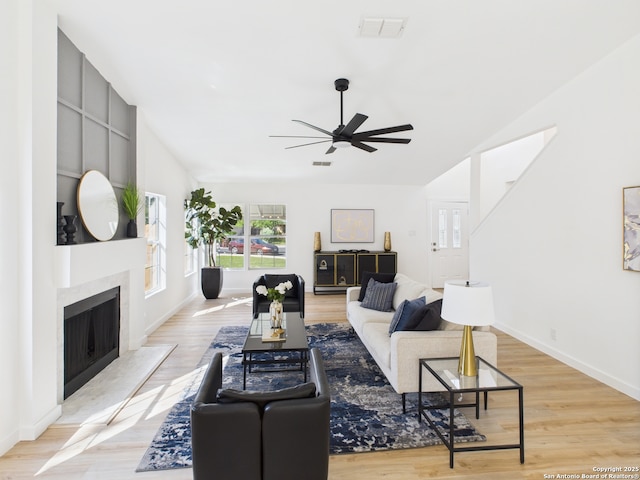7007 Elk Trl, San Antonio, TX 78244 - living room featuring lofted ceiling, ceiling fan, a high end fireplace, and light wood-style floors