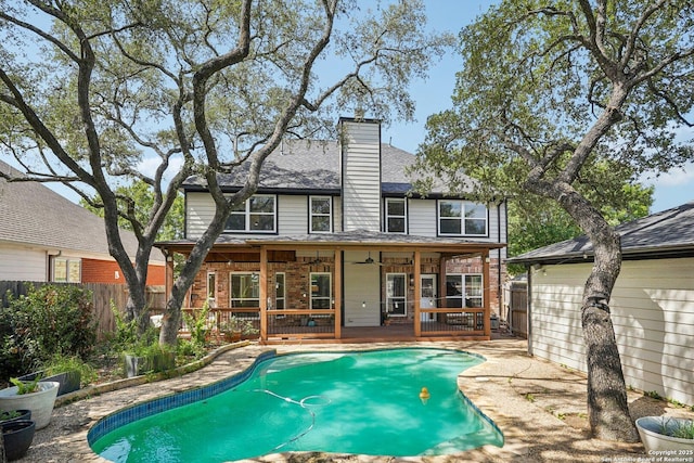 1159 Bluff Frst, San Antonio, TX 78248 - back of property with a ceiling fan, a deck, brick siding, a chimney, and roof with shingles