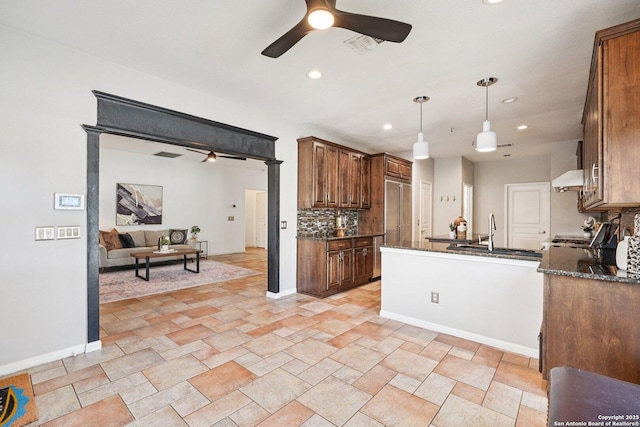 1159 Bluff Frst, San Antonio, TX 78248 - kitchen featuring a ceiling fan, recessed lighting, backsplash, open floor plan, and hanging light fixtures