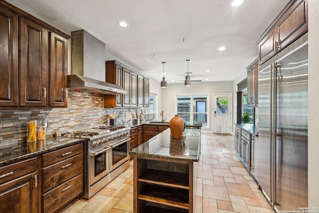 1159 Bluff Frst, San Antonio, TX 78248 - kitchen featuring high quality appliances, wall chimney range hood, open shelves, backsplash, and recessed lighting