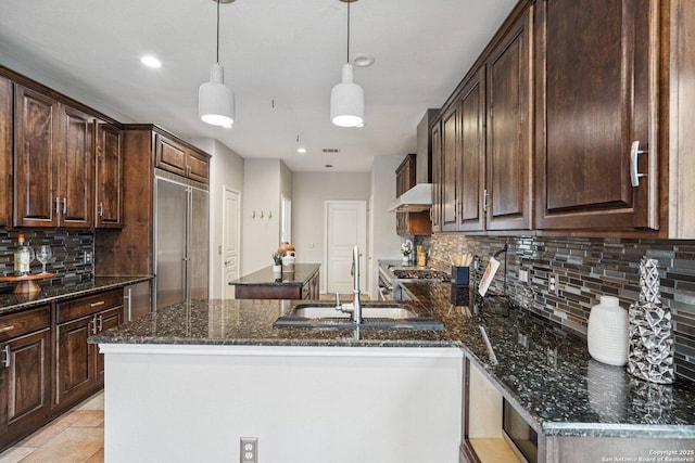 1159 Bluff Frst, San Antonio, TX 78248 - kitchen with a kitchen island, backsplash, dark brown cabinets, premium range hood, and recessed lighting