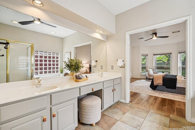 1159 Bluff Frst, San Antonio, TX 78248 - ensuite bathroom featuring a ceiling fan, double vanity, a shower stall, tile patterned floors, and recessed lighting